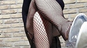 Playing in fishnets ouside in clear heels.