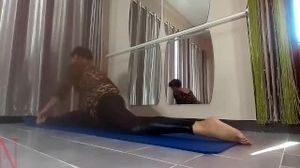 Regina Noir. Yoga in sexy leotards and latex leggings is doing yoga in the gym.