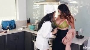 Dark-haired lesbians licking wildly in the kitchen