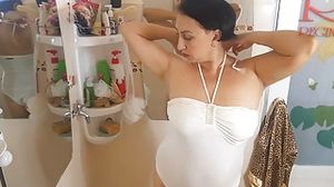 Nice lady in the shower room rubs cosmetic massage lotion oil on her beautiful legs. cam 1-2