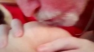 Close-up of John tonguing and blowing on Jens nip