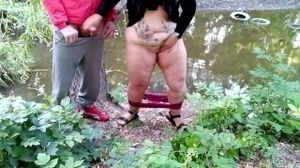 Curvy MILF with big ass masturbating jerking off big cock outdoors