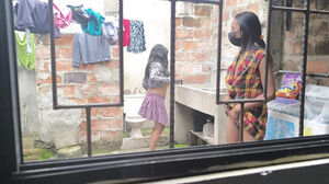 My dark-haired neighbor observes me while I do the laundry and kneads my globes.