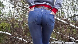 Cougar In taut Blue denim taunt Her huge arse Outdoors