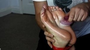 Oily feet tied and tickled