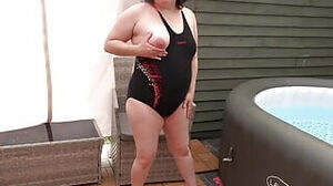 Tarty wifey with ginormous globes posing in marvelous dark-hued bathing suit and sandals