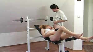 Damsel exercising on his rock hard club in the gym