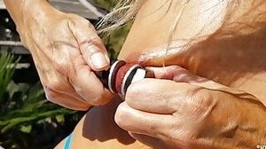 nippleringlover horny milf masturbating outdoors in pool inserting huge screws in extreme stretched pierced nipples