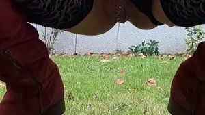 MILF has a big urge to piss, she goes to her garden, keeping only her stockings and her red boots