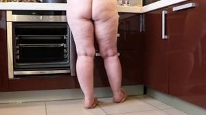 Naked mature bbw in the kitchen. plump legs.