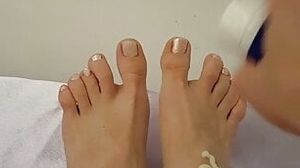 White nail varnish and massage with foot cream
